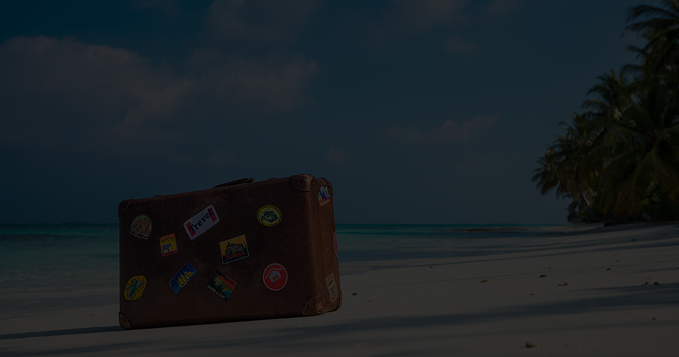 Brown suitcase on the beach.