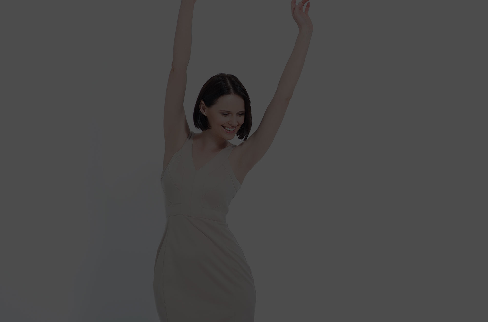 Woman smiling with hands up in the air.